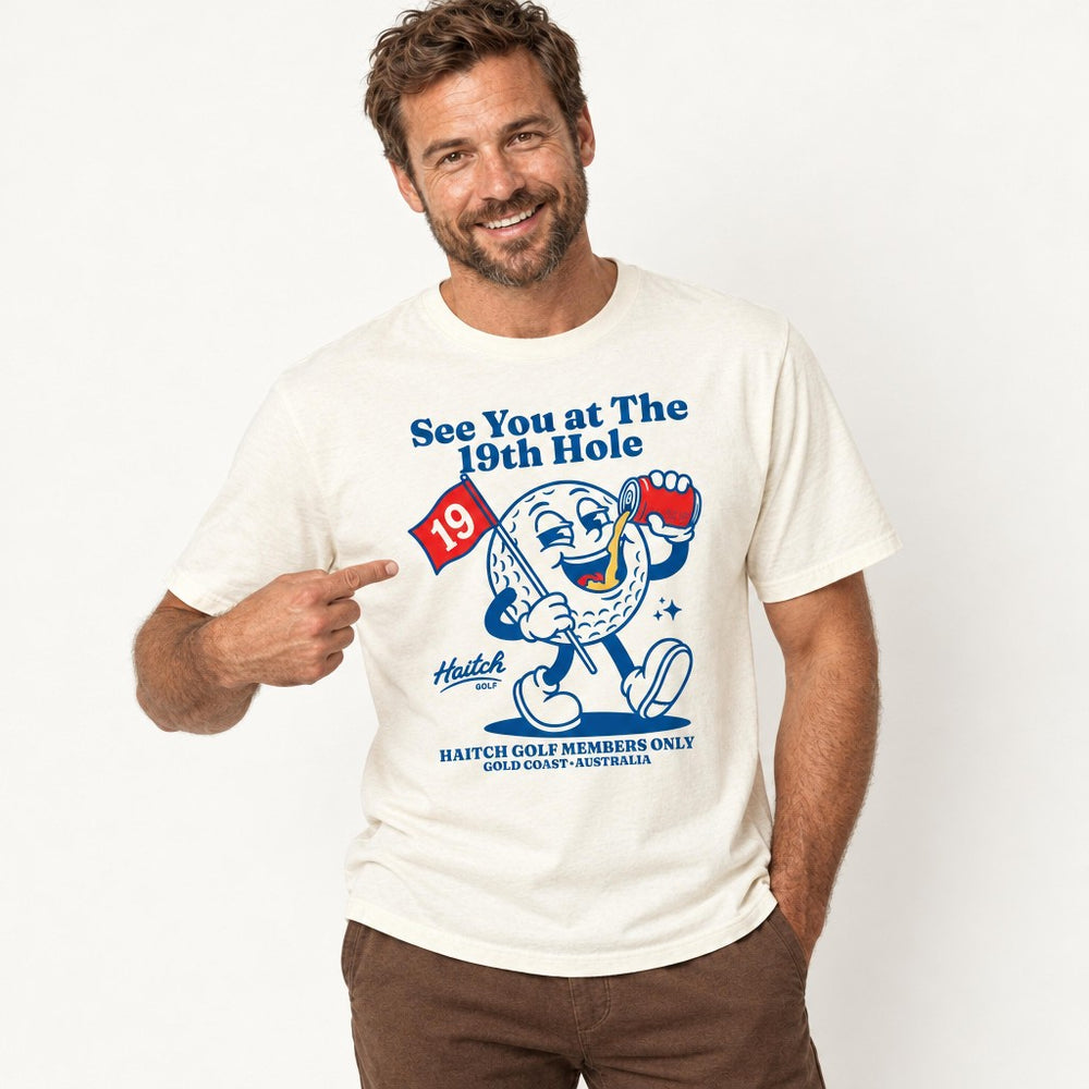 Man wearing the Haitch Golf 19th Hole Members Club tee in Natural