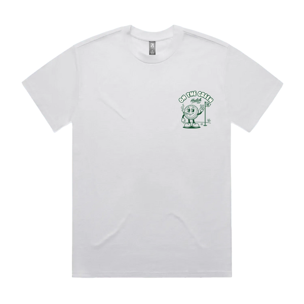 A white short-sleeve crewneck t-shirt with a small green graphic on the left chest featuring a cartoon character and the text 'ON THE GREEN'.