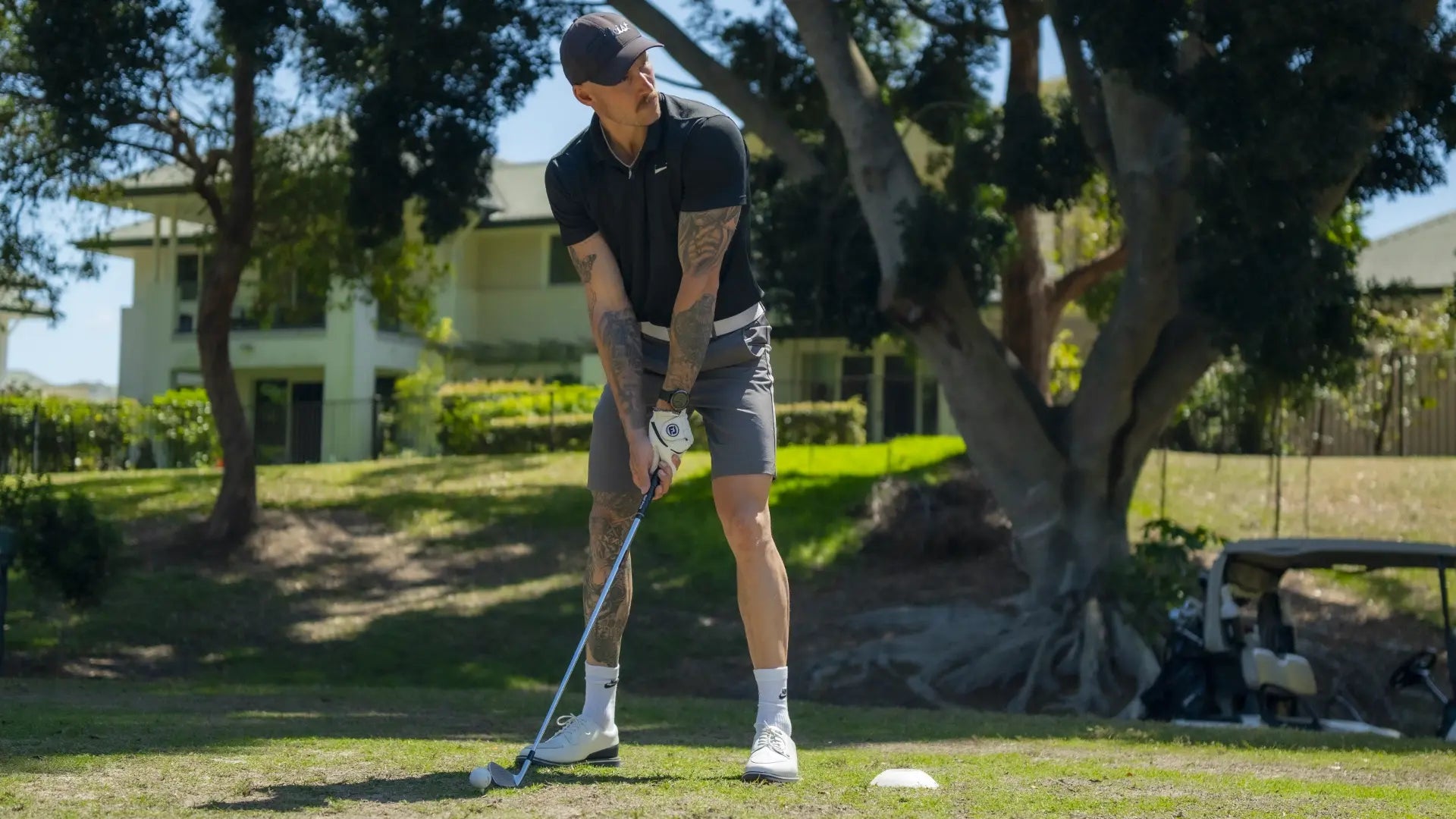 Golfer hitting iron off the tee